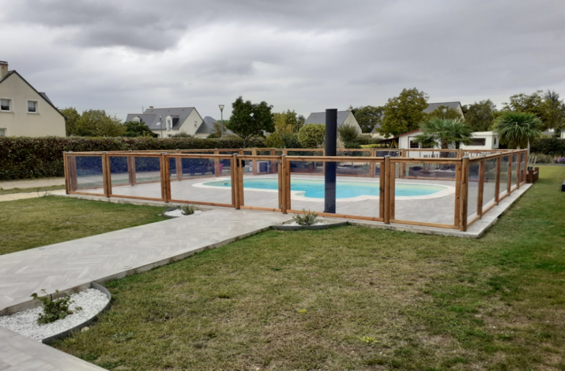 Piscine d&eacute;limit&eacute;e par une cl&ocirc;ture